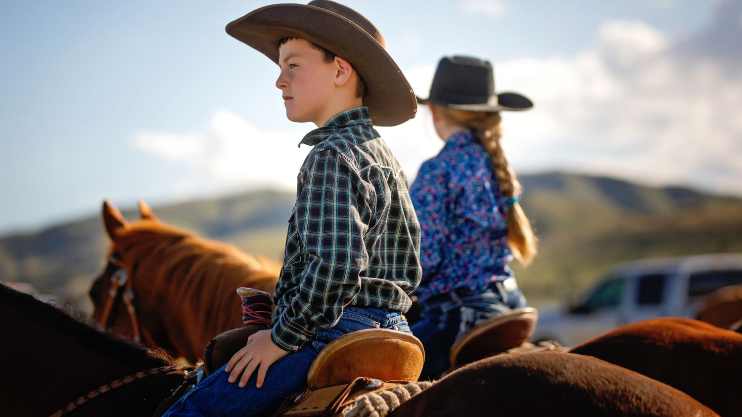 boy and girl on ranch horses